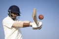 A cricketer playing cricket on the pitch in white dress for test matches. Sportsperson hitting a shot on the cricket ball