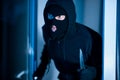 Criminal breaking in an apartment or office with a knife Royalty Free Stock Photo