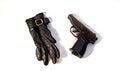 The crime. Contract kill. Killer. Black leather glove and gun on a white background. Black and white photography. Concept