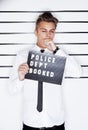 Crime, mugshot and face of man on a white background for suspect for criminal, illegal or fraud activity. Police station