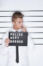 Crime, mugshot and man on a white background for suspect for criminal, illegal and fraud activity. Police station