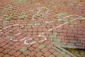 Crime scene with human body outline by chalk,drawing on the pavement.