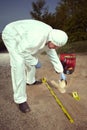 Technician Criminologist preparing tire print left in dust of field way for documentation Royalty Free Stock Photo