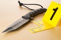 Crime scene investigation CSI evidence marker with knife on wood floor background at crime scene - police, evidence or forensic