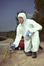 Technician Criminologist preparing tire print left in dust of field way for documentation Royalty Free Stock Photo