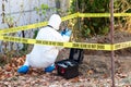 Crime scene investigation. Forensic science specialist photographing human remains. Royalty Free Stock Photo