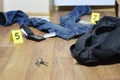Crime scene investigation - numbering of evidences after the murder in the apartment. Keys, wallet and clothes with evidence Royalty Free Stock Photo