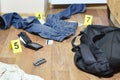 Crime scene investigation - numbering of evidences after the murdering in apartment. Brass knuckle, wallet and clothes with Royalty Free Stock Photo