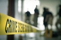 crime scene tape with blurred forensic law enforcement background in cinematic tone Royalty Free Stock Photo