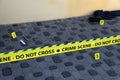 Crime scene tape for covering the area cordon. Yellow tape with blurred forensic law enforcement background in cinematic tone Royalty Free Stock Photo