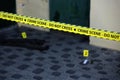 Crime scene tape for covering the area cordon. Yellow tape with blurred forensic law enforcement background in cinematic tone Royalty Free Stock Photo