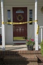 Crime scene tape at entrance to a residence Royalty Free Stock Photo