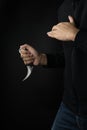 A murderer with a karambit knife trying to kill victim