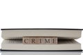 Crime written on wooden blocks inside a book isolated on a white background Royalty Free Stock Photo