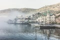 Crimea, Sevastopol, Balaklava A pier with yachts and a building.Castle, fog and the sea Royalty Free Stock Photo