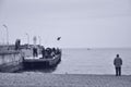 Crimea Yalta quay of the Black sea fishermen at the lighthouse in autumn birds fly Seagull