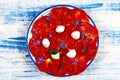 Crimean Black Tomato Salad on a Blue and White Background, top view