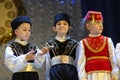 Crimean Tartar children in native costumes singing native song on stage. Celebrating Nowruz. Kyiv, Ukraine