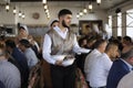 At the Crimean Tartar restaurant: waiter in Tartar native dress setting the table