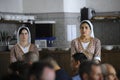 At the Crimean Tartar restaurant: waitress in Tartar native dress setting the table