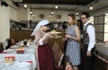 At Crimean Tartar restaurant: waitress in Tartar native dress standing in the middle of a dining room with dishes in hands,