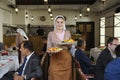 At the Crimean Tartar restaurant: waitress in Tartar native dress setting the table