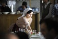 At the Crimean Tartar restaurant: waitress in Tartar native dress setting the table