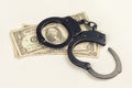 Criminal. Handcuffs on money.