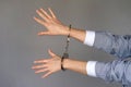 Criminal hands locked in handcuffs. Royalty Free Stock Photo