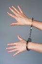 Criminal hands locked in handcuffs