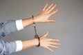 Criminal hands locked in handcuffs. Royalty Free Stock Photo