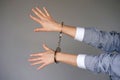 Criminal hands locked in handcuffs Royalty Free Stock Photo