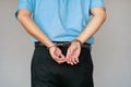 Criminal hands locked in handcuffs. Close-up view Royalty Free Stock Photo