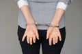 Criminal hands locked in handcuffs. Close-up view Royalty Free Stock Photo