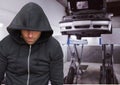 Criminal with hood in car theft mechanics fraud