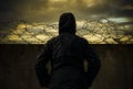 Prison. A man at the prison wall with barbed wire at sunset. Crime and lawlessness Royalty Free Stock Photo