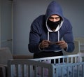 Criminal stealing baby in human child traficking concept Royalty Free Stock Photo