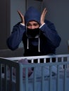 The criminal stealing baby in human child traficking concept Royalty Free Stock Photo