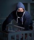 Criminal stealing baby in human child traficking concept Royalty Free Stock Photo