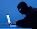Criminal Using Laptop To Hack Data At Table Royalty Free Stock Photo