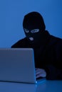 Criminal Using Laptop To Hack Online Account Royalty Free Stock Photo