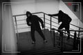 Criminals in masks on stairs, view through CCTV camera