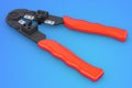 Crimper, crimp tool on blue background, 3D rendering