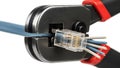 Crimping Tool Compressing Ethernet Network Cable Connector with Wires Exposed Keywords: crimping tool, ethernet cable, network Royalty Free Stock Photo