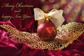 Crimson christmas bauble on openwork golden leaf Royalty Free Stock Photo