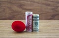 Crimson nest egg with American and Chinese currency reflects risky business dangers