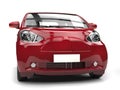 Crimson red metallic small urban modern electric car - front closeup