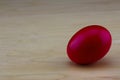 Crimson red nest egg on wood background