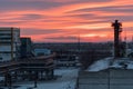 Crimson sunrise over the factory. Winter