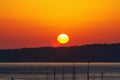 Crimson sunrise over the hill near the seaport. The moment of the beginning of a new day, a symbol of the onset of Royalty Free Stock Photo